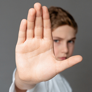 boy showing stop gesture with his hand