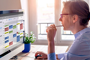 person using calendar on desktop computer