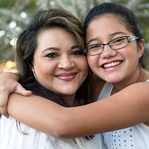 smiling mom and daughter hug