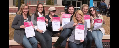 a group of people holding up written statements