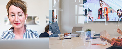 woman looks at computer screen, people in a meeting room look at meeting onscreen