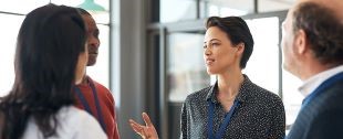 woman speaking to colleagues