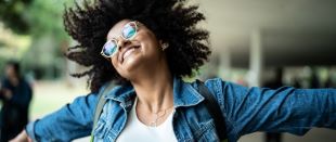 woman smiling with arms wide