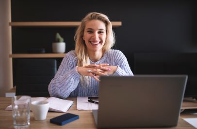 woman at laptop smiling