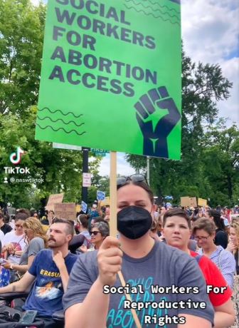 screenshot of tiktok with person holding sign stating social workers for abortion access