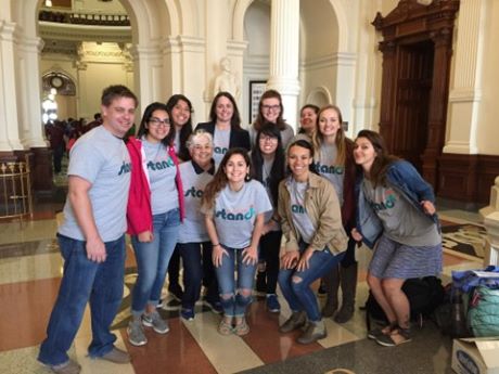 people standing in a government building with social workers stand up shirts