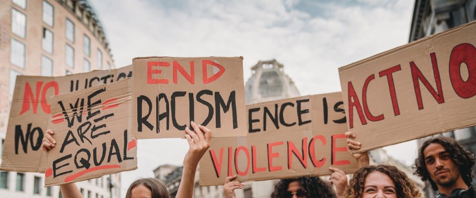People with antiracism signs at a protest
