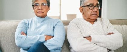 couple on couch looking frustrated
