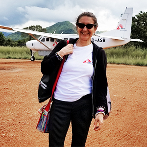 Athena Viscusi with small airplane and mountain