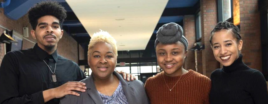 four people standing together