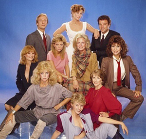group of actors wearing 1980s hairstyles and clothing