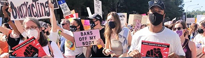 group of people marching at a rally