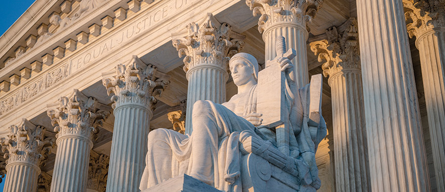 stone statue seated outside the Supreme Court building