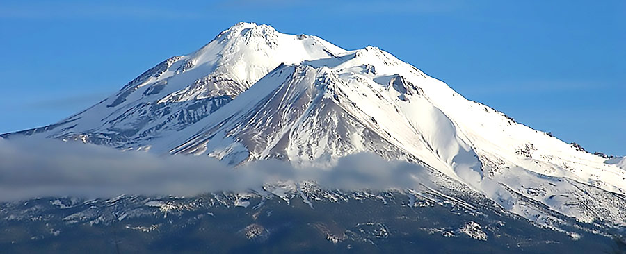 snow-covered Mount Shasta with wispy clouds
