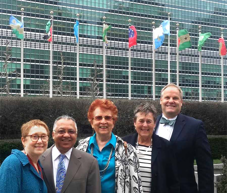 group of people with United Nations building in background
