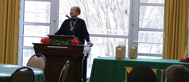 woman stands at a podium