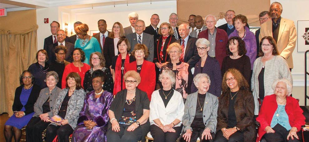 group of adults pose for the camera