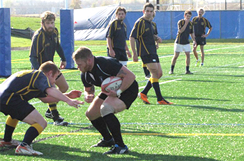 men playing rugby outdoors