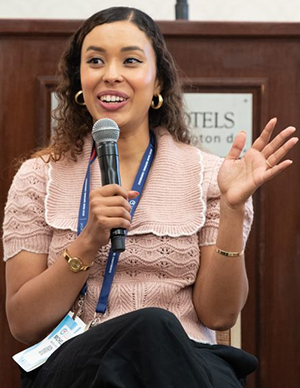 woman holds the mic while asking a question