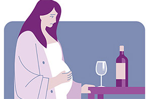 pregnant woman looks at wine bottle