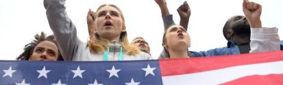 People chanting and holding american flag