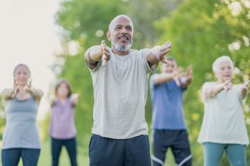 persons outdoors practicing tai chi