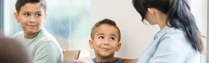 Child looking happily at teacher