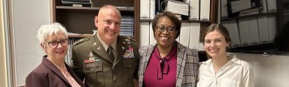 3 people with person in uniform