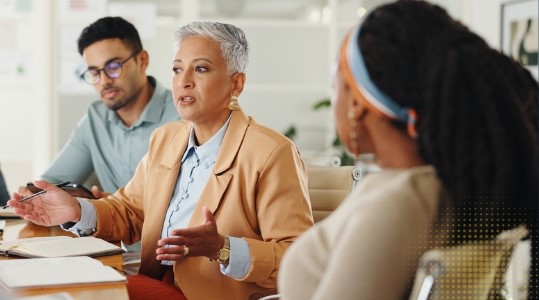two women and a man around a table