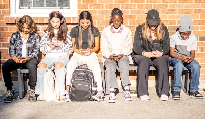 adolescents looking at phones