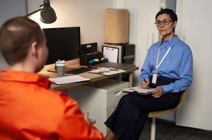 woman sitting with inmate