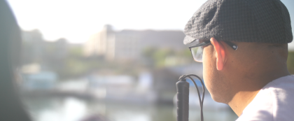 person with cane looking over a river