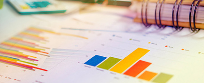 various graphs of data with spiral notebook