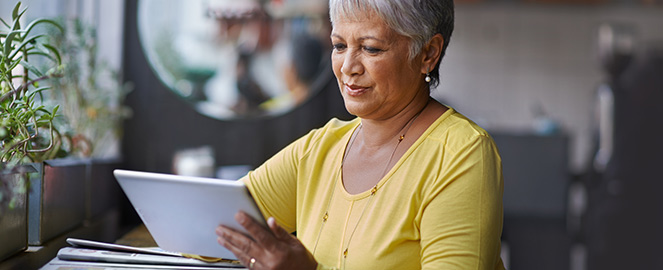 woman reads on a tablet computer