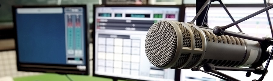 microphone and desktop screens in a radio studio