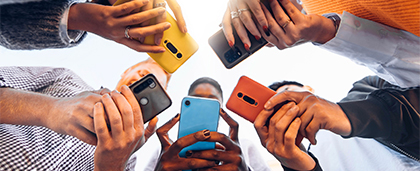 group of people using mobile phones with colorful covers