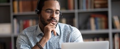 man with headphones watching a video