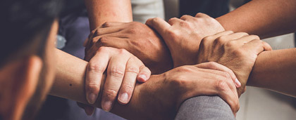 group of hands clasping