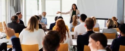 woman standing in front of group giving a presentation