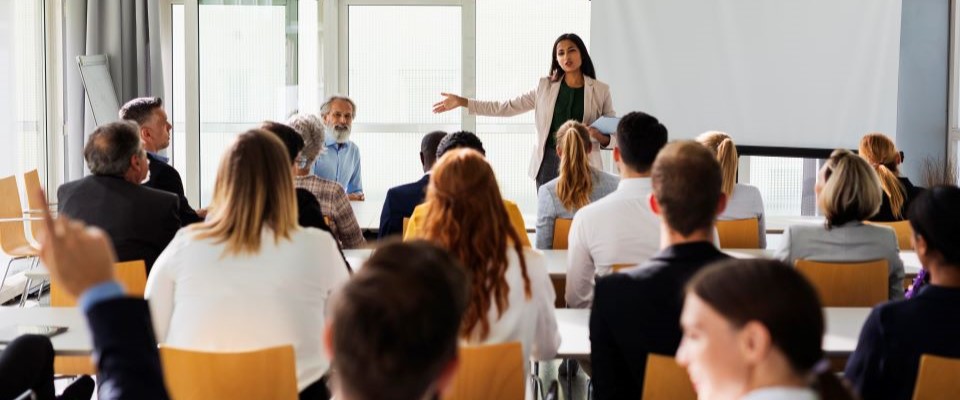 woman standing in front of group giving a presentation