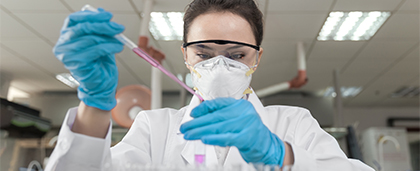 scientist in protective gear working in a laboratory