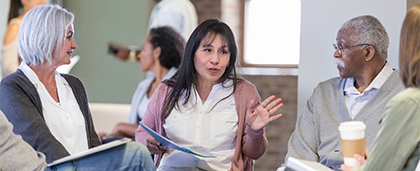 woman speaking in a seated group