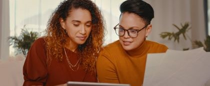 two people look at computer screen together