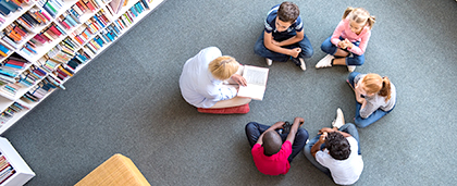 adult reading to a group of children