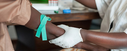 person with surgical glove holds a patient's arm