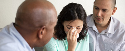 two people watch with empathy as person cries