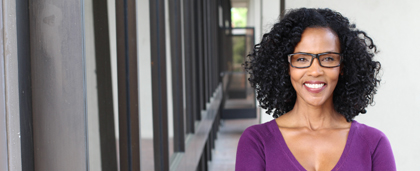 smiling woman standing in a hallway