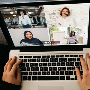 hands on a laptop, webinar on screen