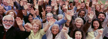 group of people with hands reaching toward camera