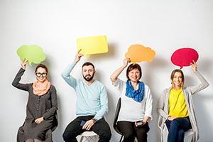 people holding talk bubbles over their heads